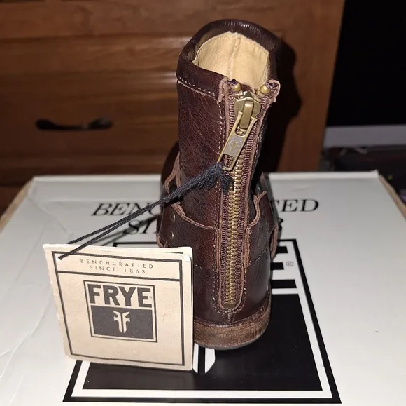 A pair of Frye Phillip Harness dark brown ankle boots in a women's size 6. EUC
