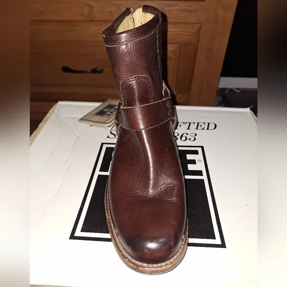 A pair of Frye Phillip Harness dark brown ankle boots in a women's size 6. EUC