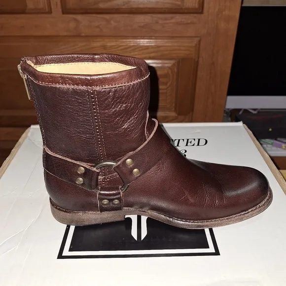A pair of Frye Phillip Harness dark brown ankle boots in a women's size 6. EUC