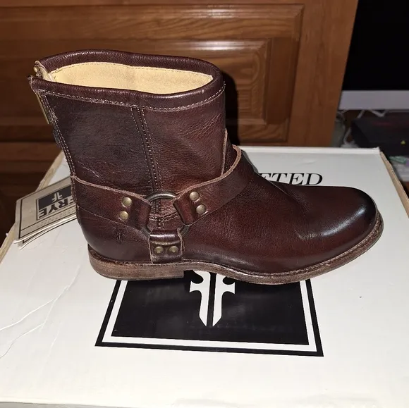 A pair of Frye Phillip Harness dark brown ankle boots in a women's size 6. EUC