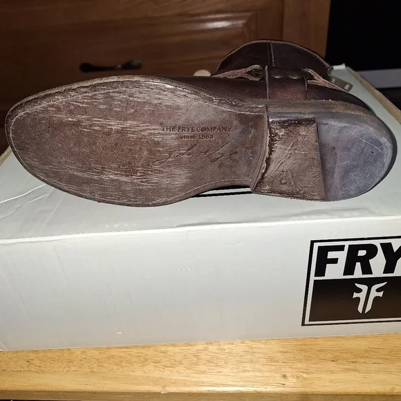 A pair of Frye Phillip Harness dark brown ankle boots in a women's size 6. EUC