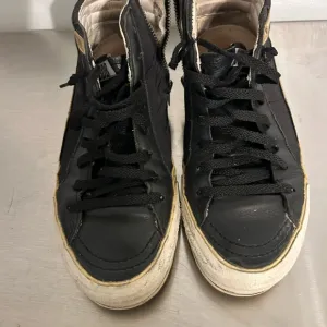 Golden Goose Black and Gold Sneakers with Vintage Appeal